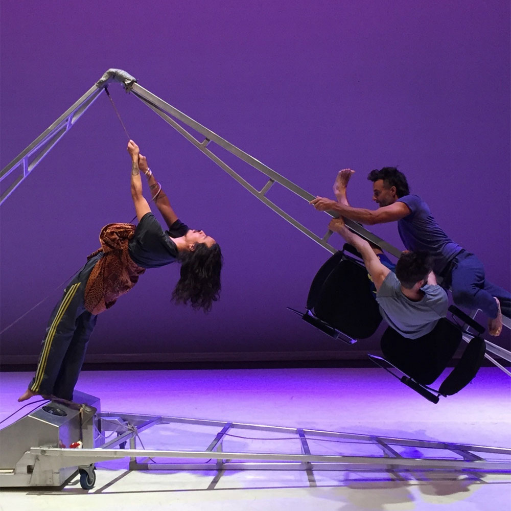 Dance artists from Mascall Dance performing on an installation made up of a ladder like framework