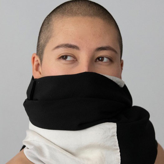 Head shot Shion Skye Carter with a black and white scarf wrapped around her head, covering her neck, mouth and nose